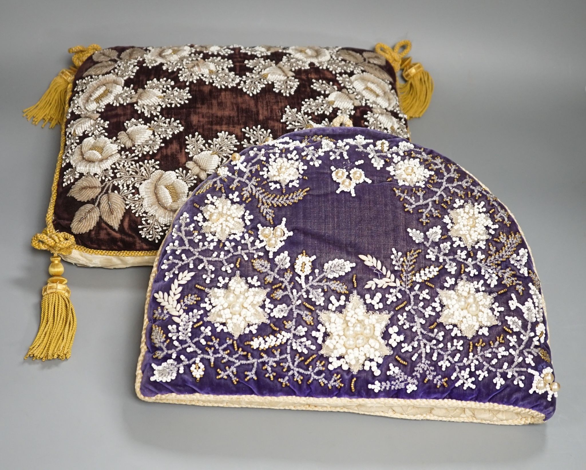 A 19th century Berlin bead worked tea cosy on purple velvet with a similar cushion, Cushion 36 cms wide x 32 high.